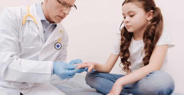dermatologist examining pediatric patient