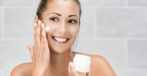 woman applying face lotion