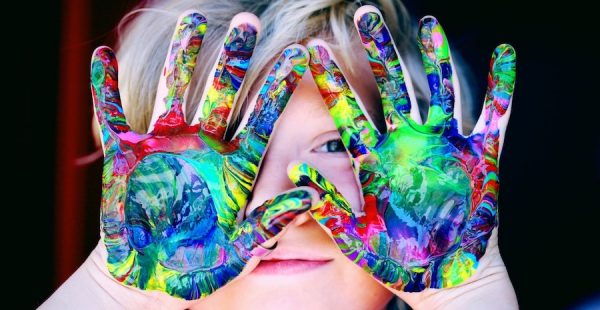 kid with paint on hands
