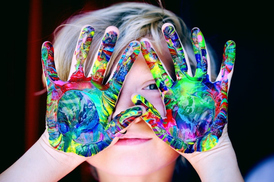 kid with paint on hands