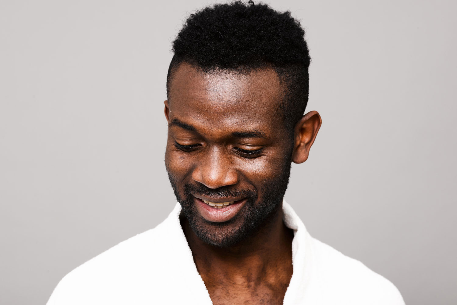 man looking down with full head of hair