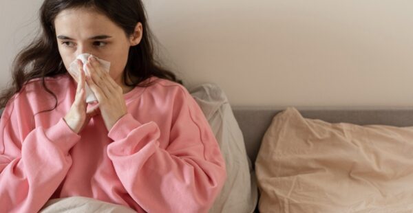 Woman blowing her nose