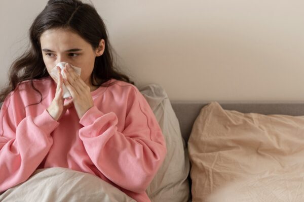 Woman blowing her nose